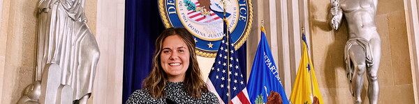 NWU female student at a podium in at the Department of Justice in Washington D.C.
