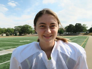 Nataly Miller on the NWU football field wearing a football uniform.